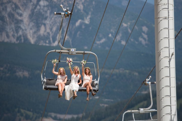 Three women in dresses take a ride on Swift Current 4, a high speed quad.